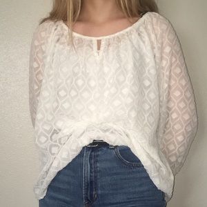 See through white polka dot white blouse.